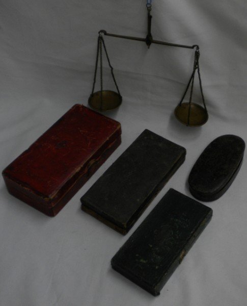 Four boxes of Mining Scales: Lot of three miner's scales in four boxes. One is in a wooden box, 6 7/8" x 3 1/2", covered w/red leather w/impressed design on top. Contains 2 1/8" pans suspended from a 5 3/4" beam; weights include 