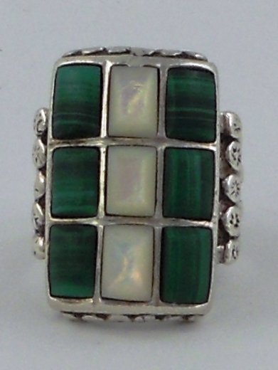 Silver ring with Jade & Mother of Pearl: This is a sparkling large Sterling Silver ring, with 3 pieces of mother of pearl surrounded by 6 pieces of what looks like stripped green Jade. It's an older ring that is unmarked. The face is large a