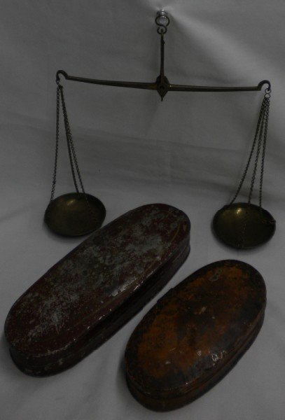 Two Sets of Miners' Scales: Lot of two scales. One is in an orange, oval metal box, measuring 6 1/8" x 3 1/2", with an eagle and decorative border on lid top. Beam measures 5 7/8" long with 2 3/8" pans; except for the 6 DWTS and