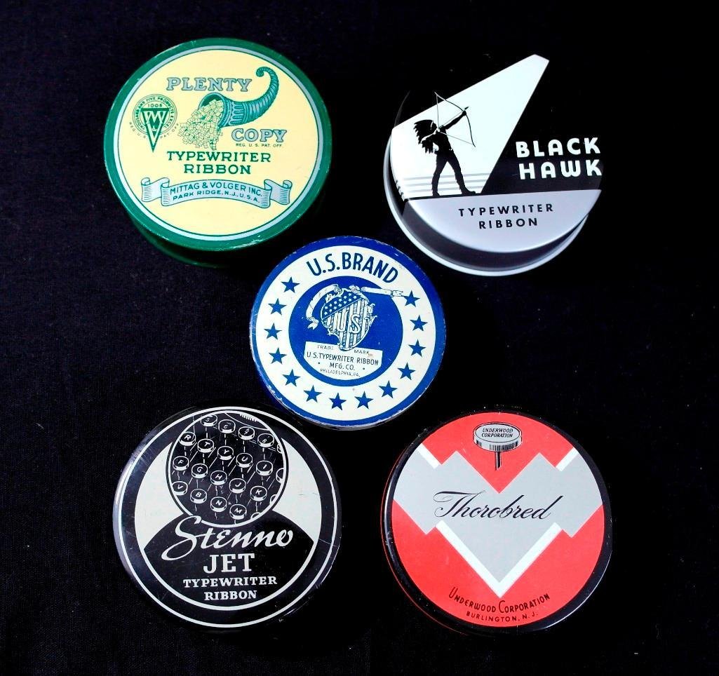Lot of 5 Vintage Round Typewriter Ribbon Tins - One w/: This lot of 5 vintage round typewriter tins are all from various brands. One tin, U.S. Brand, still has its original ribbon inside. The tins measuresapprox. 2.5" in diameter. The brands included are: 