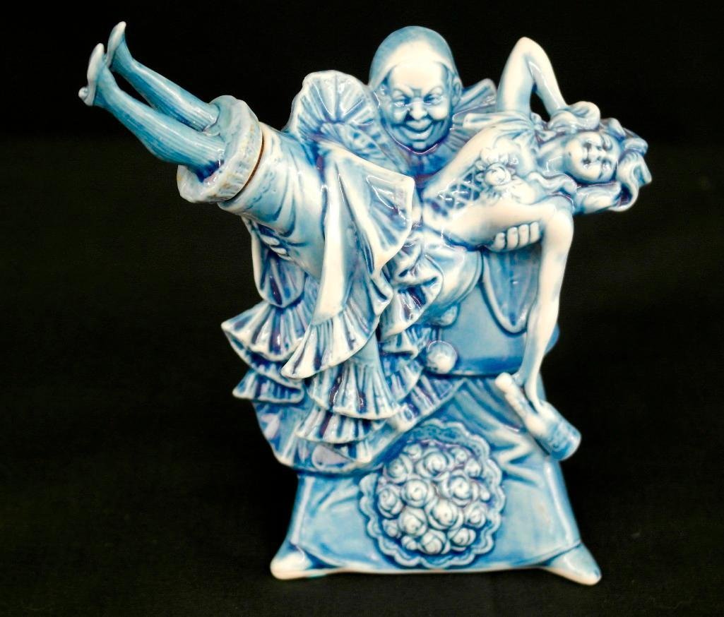 Schafer & Vater Blue Figural Nipper Flask - Evil Clown: This Schafer & Vater blue nipper depicts an evil clown holding a drunk cabaret girl in his arms. It is very detailed and comes with the original stopper - the girl's legs. There are no chips, cracks o