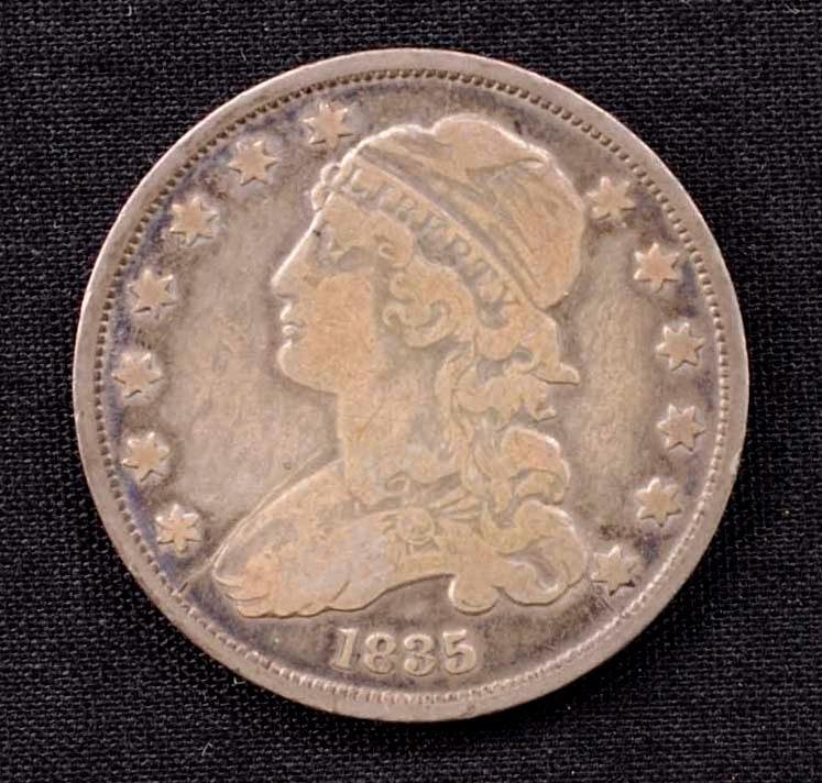 1835 United States Liberty Cap Quarter: This lot is for a United States Liberty Cap Quarter. The coin is from 1835 and features classic head left flanked by stars with an eagle with arrows in his talons on back. This is fresh out of a local