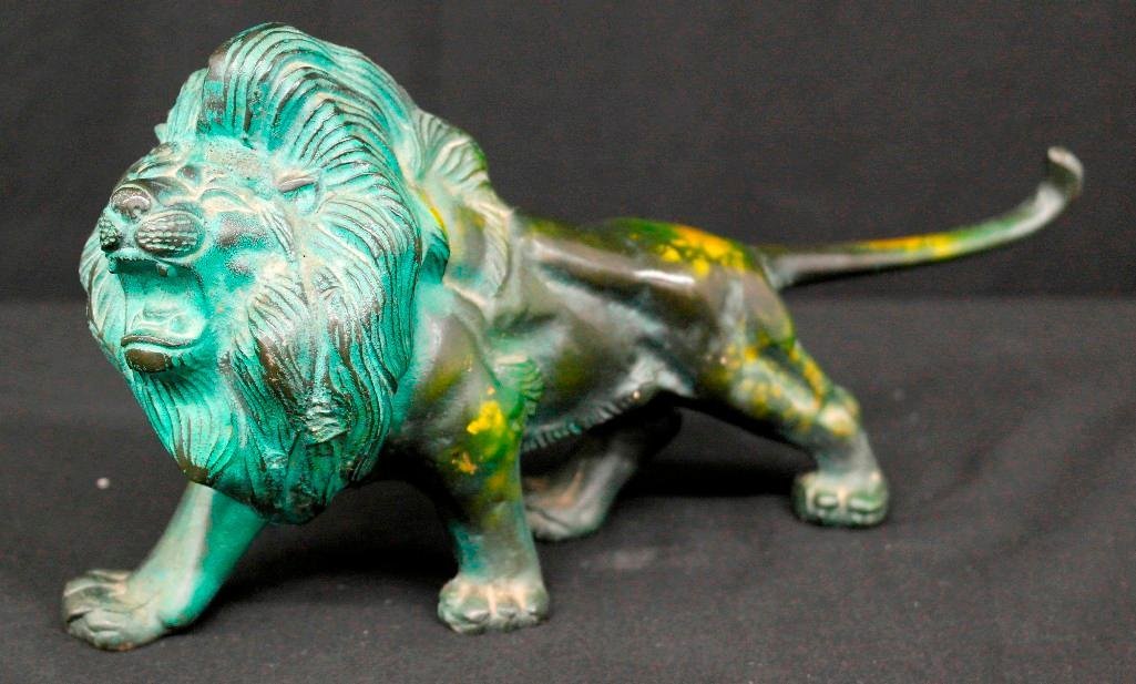 Roaring Iron Cast Bronze Statue: This a cast bronze statue is of a roaring lion. It has an aged green patina to it with some other unidentifiable yellow marks throughout. The statue is in very good condition and measures approximatel