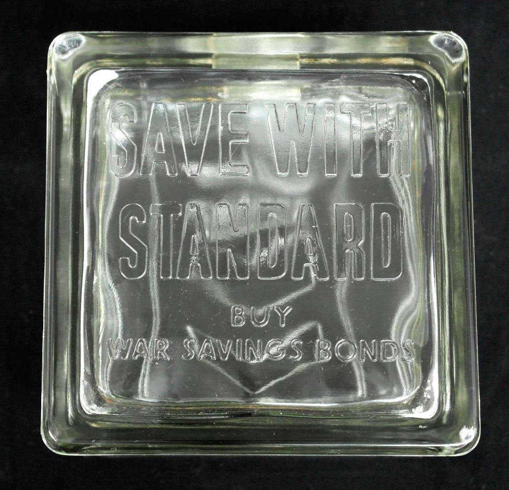 Standard Oil World War II Glass Block Bank: This bank was given out by Standard Oil Company to promote saving for War Bonds. One side states, "Save With Standard - Buy War Savings Bonds," and the other reads, "Quality Service Standard" with the