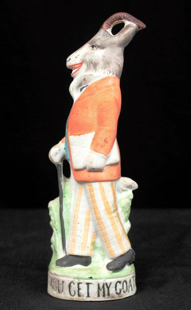 "You Get My Goat" Schafer & Vater Colored Nipper Flask: This Schafer & Vater piece is a colored nipper flask in the Animal theme. It is titled, "You Get My Goat," and features a large goat dressed like a man and is walking upright with a cane in one hand a