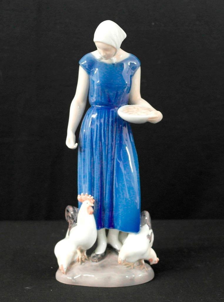 Bing & Grondahl Farmer Girl Figurine: This lot is for a very well made realism figurine. It is of a country farm girl feeding the chickens and rooster. It is from the Denmark maker Bing & Grondahl and is number 2220. The marks on the bott