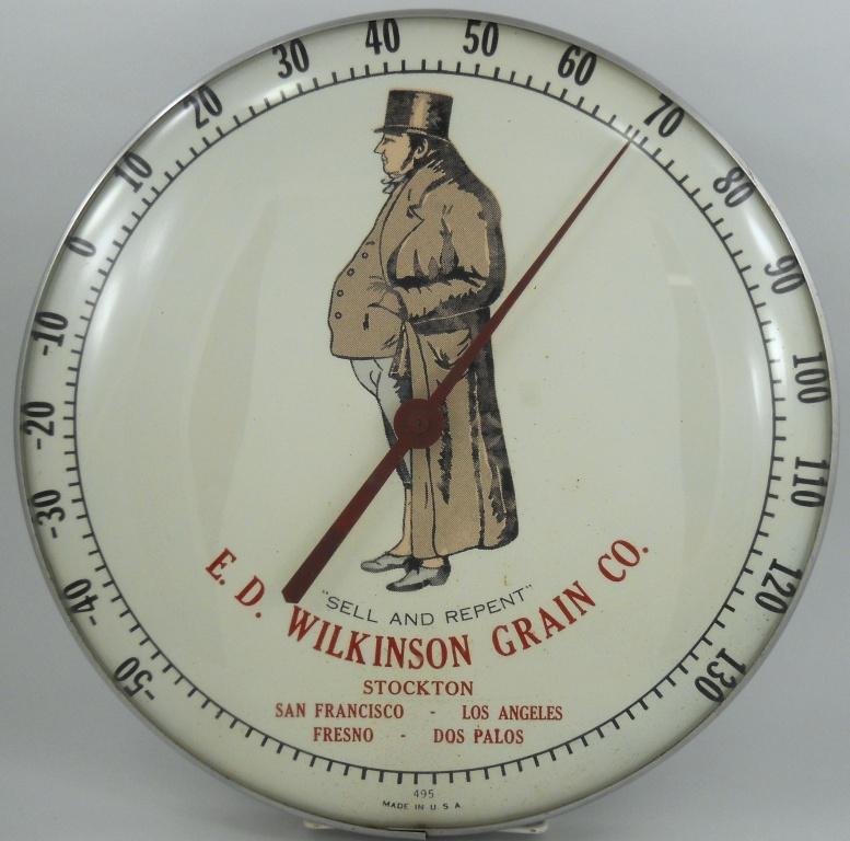 E. D. Wilkinson Grain Co. Round Glass Thermometer: This round glass thermometer from E. D. Wilkinson Grain Company of California is approximately 12" in diameter. The E. D. Wilkinson Grain Company was incorporated in May 1946 and its trademark is a fa