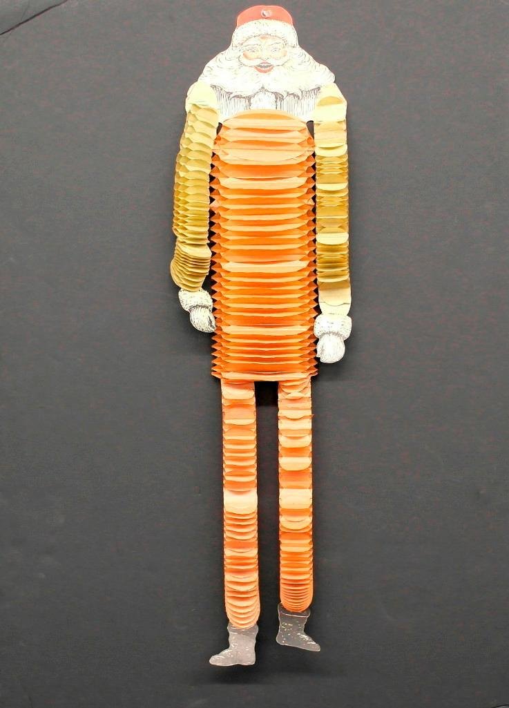 1920s "Dancing" Santa Toy: This is a 1920s tissue paper and cardboard "dancing" Santa toy. When one end of thread is tied to any object and the other end entwined around the forefinger and you shake your finger, Santa will "imi