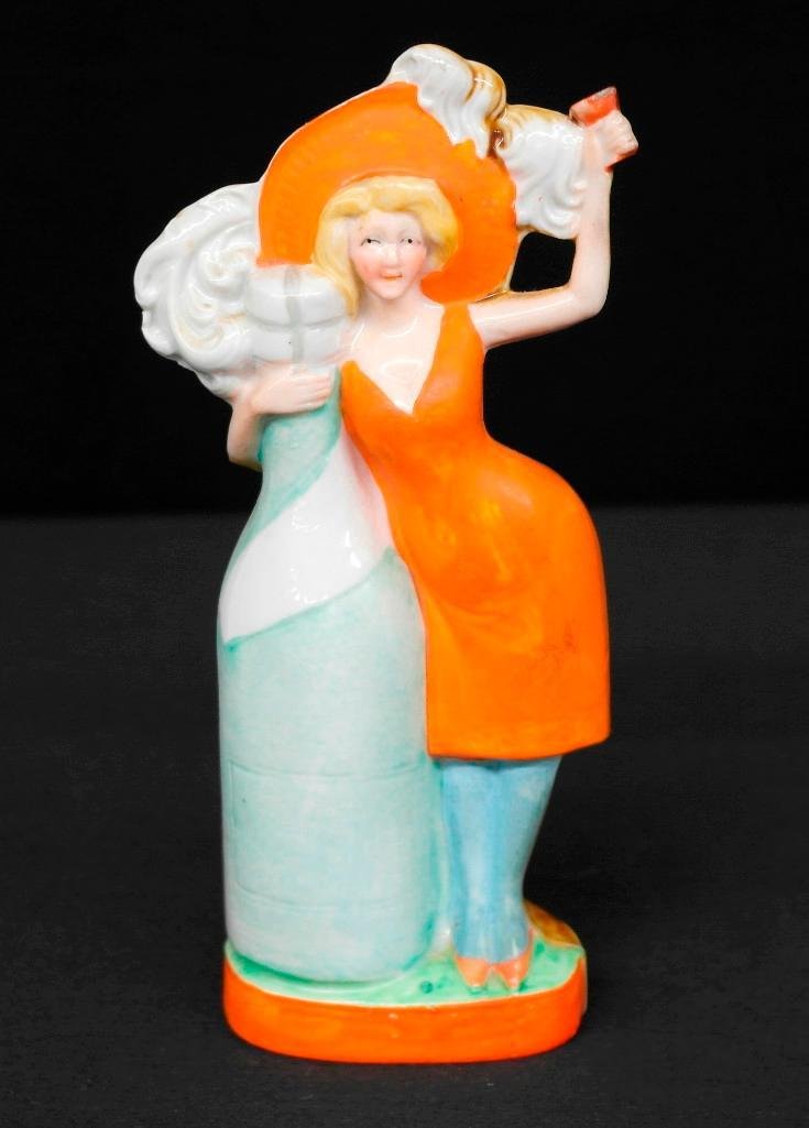 Schafer & Vater Colored Nipper Flask Hausmarke: This Schafer & Vater colored nipper flask depicts a woman holding on to a very large bottle and is referred to as Hausmarke, which translates to House Brand. As many of you know, these flasks were giv
