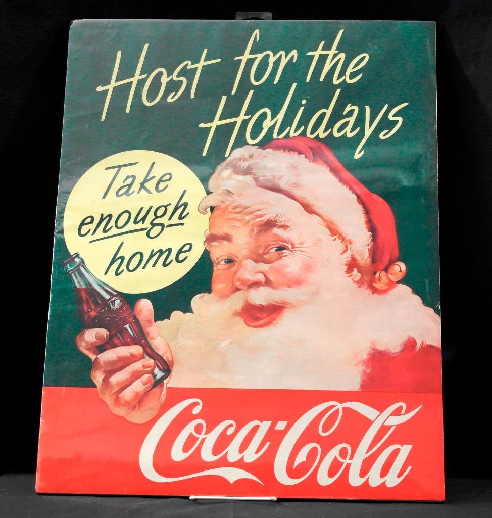 1960s Coca-Cola Santa Poster: This 1960s paper poster depicts Santa holding a bottle of Coca-Cola with the sayings, "Host for the Holidays" and "Take enough home." This poster measures approximately 17-1/2" wide x 22" tall, has ve