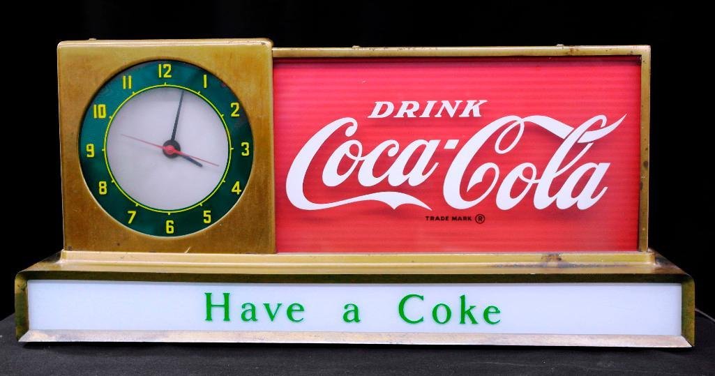 1950s Coca-Cola Lighted Counter Display Clock: This Coca-Cola counter display clock was manufactured by Price Brothers, Inc., (Chicago and New York) in the early 1950s. The clock hasa round face (the more unusual version), and the base is milk gla