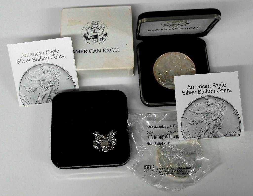 Three American Silver Eagles: This lot is for three (3) American Eagle.999 silver one-ounce dollar coins. Each is a United States mint-issued one-ounce pure silver coin. The first two are both from 1999 and come in their original
