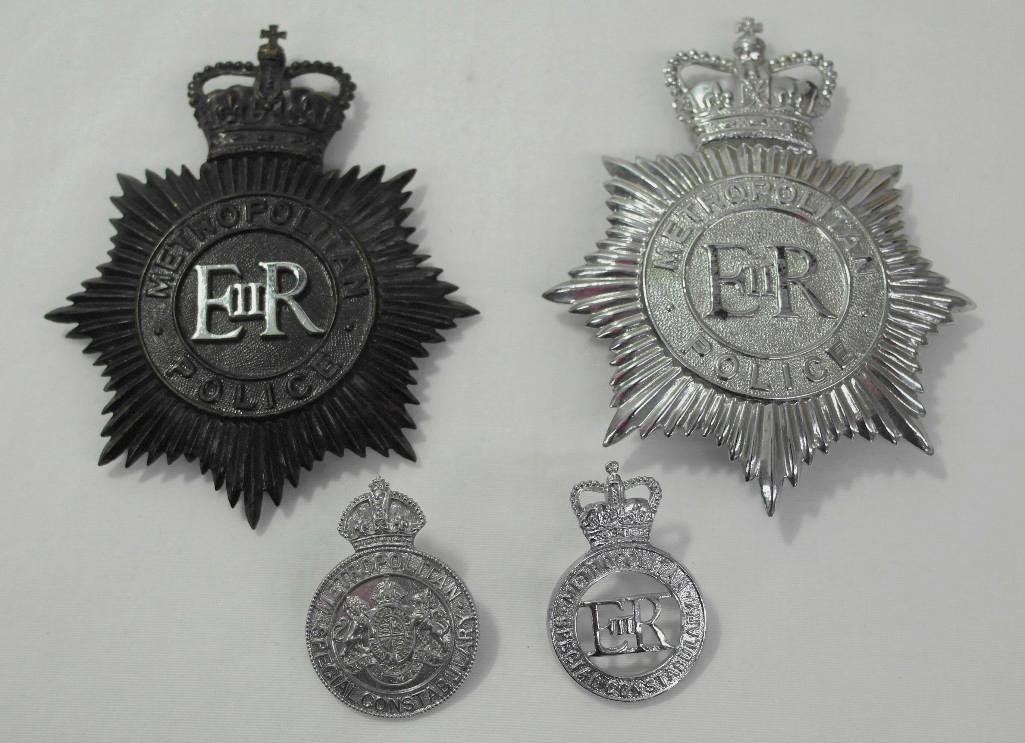 Four (4) London Metropolitan Police Hat Badges: This lot is for four (4) different badges for the London Metropolitan Police: two helmet badges and two cap badges. The helmet badges include both a black badge and a chrome badge, and both have Queen