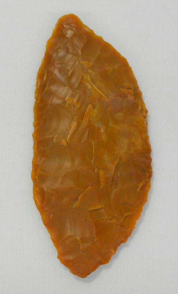 Knife from the Wakemap Mound Site: Offered is a carmel agate knife found at the Wakemap Mound site by Frank Buehler. It is a nice-sized knife at approximately 3-3/4" long x 1-1/2" wide. The color and type of stone used to mak