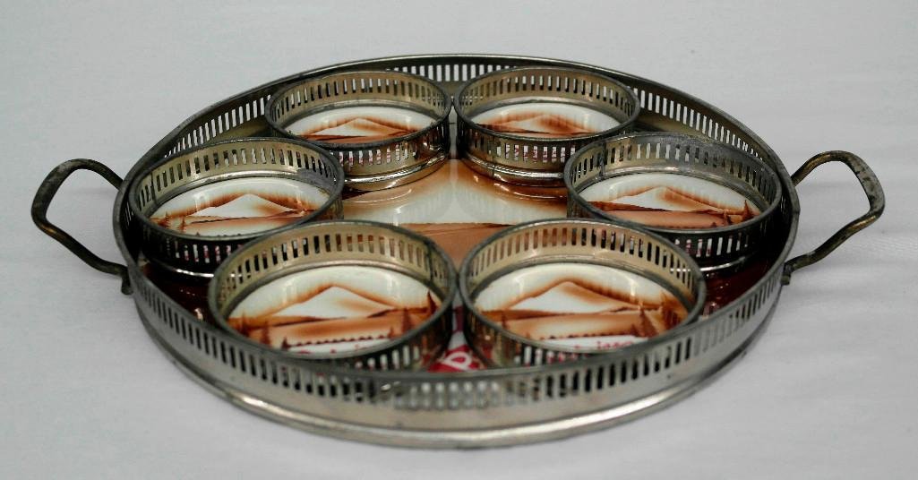 Pre-Prohibition Rainier Beer Tray and Coaster Set: Offered is a pre-prohibition Rainier tray and coaster set that was made in Germany. Each of the seven pieces has a white porcelain bottom and a plated metal outer-band or rim. Each features