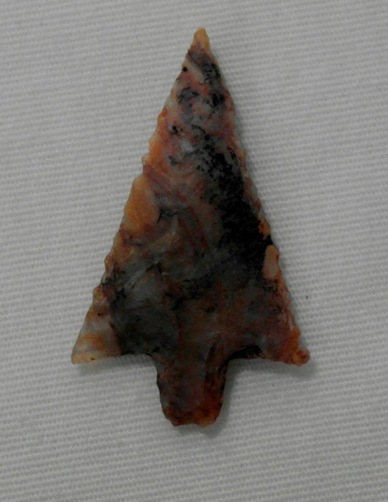 Multi-Colored Columbia River Arrowhead: This lot features a multi-colored agate arrowhead found at the Decker site. The arrowhead is 1-1/4" x 3/4" and is from the Frank Buehler collection. This location is another well-known 