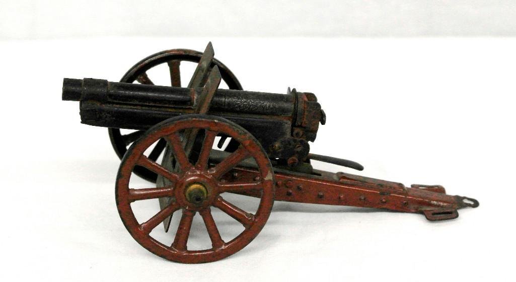 Marklin 7.7 MM Field Gun: This field gun was made by the Marklin Toy Company in Germany circa 1920. It is made of heavy tin, is complete, and appears to have the original paint. The firing mechanism not only works, but has a v