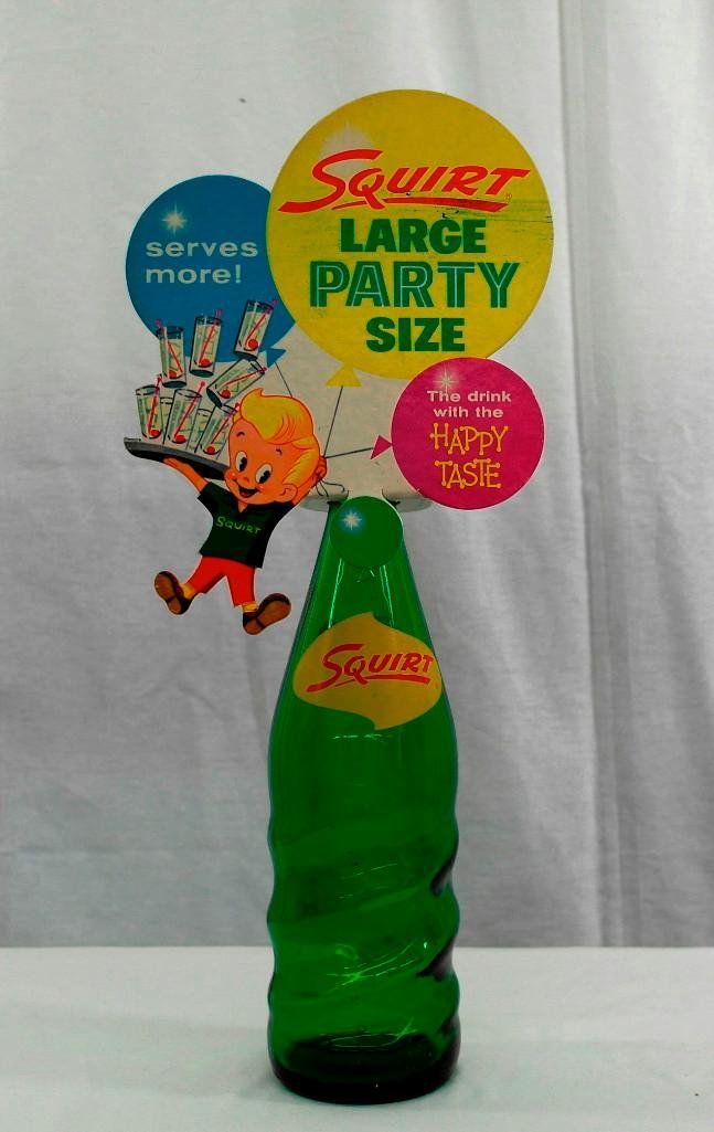 Squirt Bottle With Topper: The lot consists of both the bottle and topper. This Squirt topper has a 1960 copyright date, and the set is approximately 17" tall x 8" wide. The topper has no bends or tears, although it has some gr