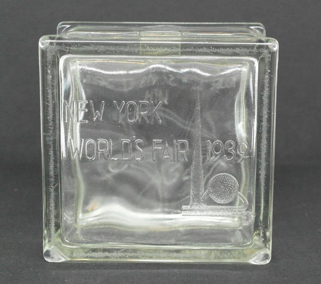 Souvenir Glass Block Bank - 1939 New York World's Fair: This pressed glass block souvenir from the 1939 New York World's Fair has a coin slot on top. The back side reads, "Watch your savings grow with Esso." The front side depict