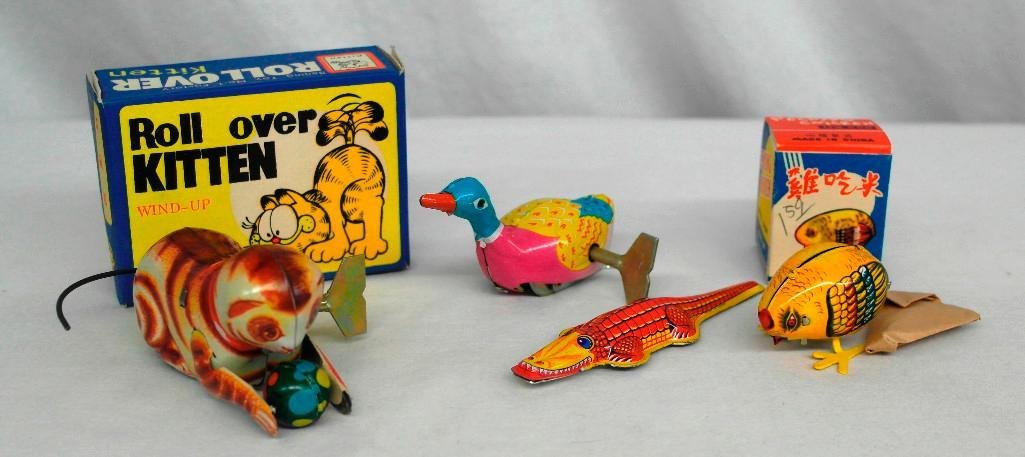4 Tin Litho Toys - Kitten, Chicken, Goose & Crocodile: Here is an assortment of four vintage tin litho toys. Included is a Roll Over Chicken and a Pecking Chicken; both are wind-up toys with their original keys and boxes. Also in the grou