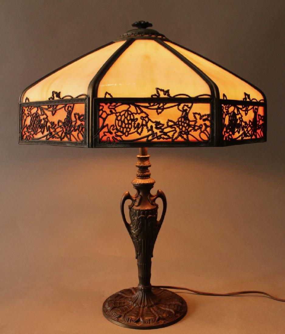 Vintage Slag Panel Table Lamp: Vintage slag panel table lamp, 8 bent caramel slag glass panels, 8 red/orange border panels with grape and leaf overlay, classic vase shaped base with handles, unsigned, "1621' raised number on bottom