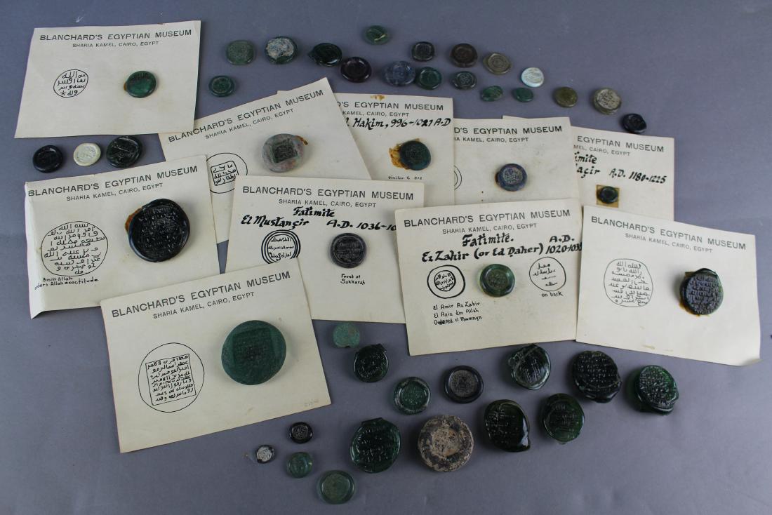 Ancient Egyptian Embossed Seals: Ancient Egyptian embossed glass seals. Forty-one individual pieces most dating to the 11th century. Used on the Silk Road trade by merchants to denote owner or quantity of order of spices, etc. Some a
