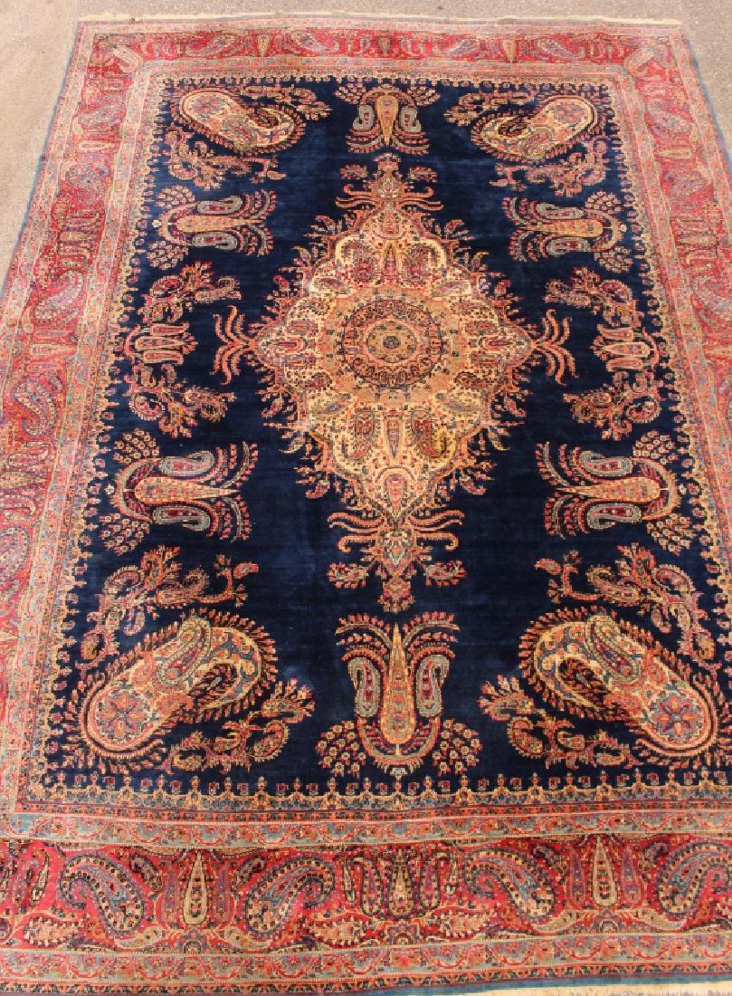 Semi-Antique Kerman Rug 13.9' x 9.9': Fine oversize semi-antique Kerman area rug, 13.9' x 9.9', center medallion on dark blue background, paisley design border, c. 1940, very good condition..