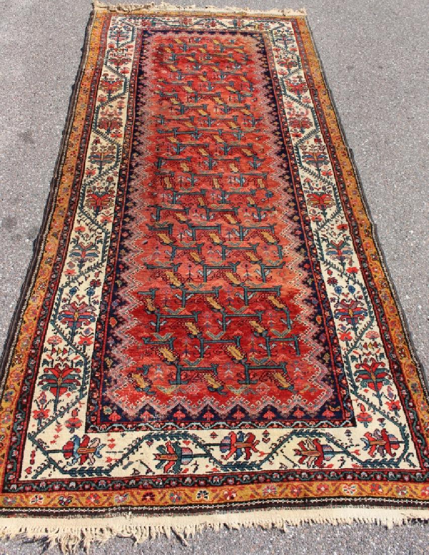 Semi-Antique Hamadan Rug 10.4' x 4.9': Semi-antique Hamadan area rug, 5 borders surrounding red geometric design field. A few minor areas clustered of wear, a quarter size moth damage (shown).