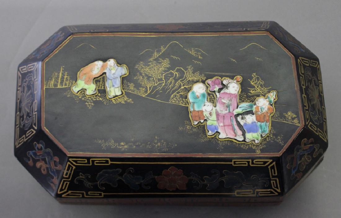 Chinese Lacquered Tea Caddy: Chinese lacquered covered tea caddy, applied porcelain figures to top, floral and Greek Key design on the oblong octagonal shape, 12.5" x 5" x 7.5", mark on bottom indicates Jiaging Dynasty, late 1800