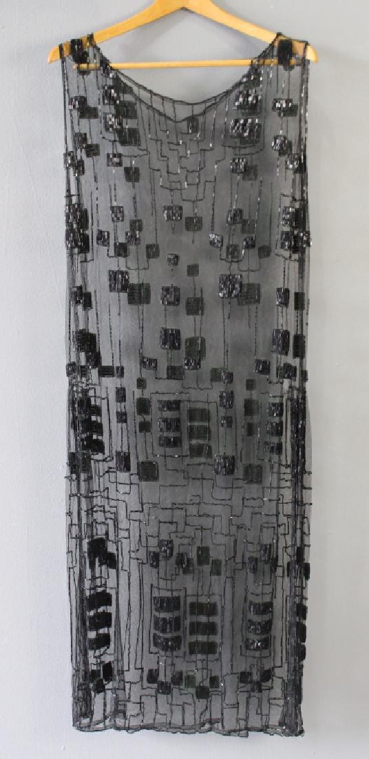 1920s Black Beaded Flapper Dress: 1920s black Flapper Era dress, geometric design beading on net fabric, 48" long, 20" side, slits on both sides, extraordinary condition.