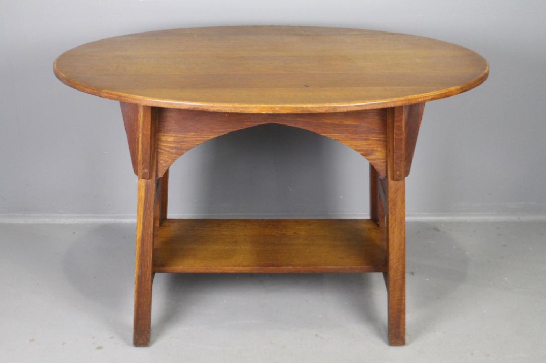 Limbert Arts & Crafts Oak Table: Limbert Arts & Crafts period oak oval top table, No. 146, 30" x 45" x 30"h, branded signature, cut-out ends, corbels, scratches and wear consistent with age and usage.