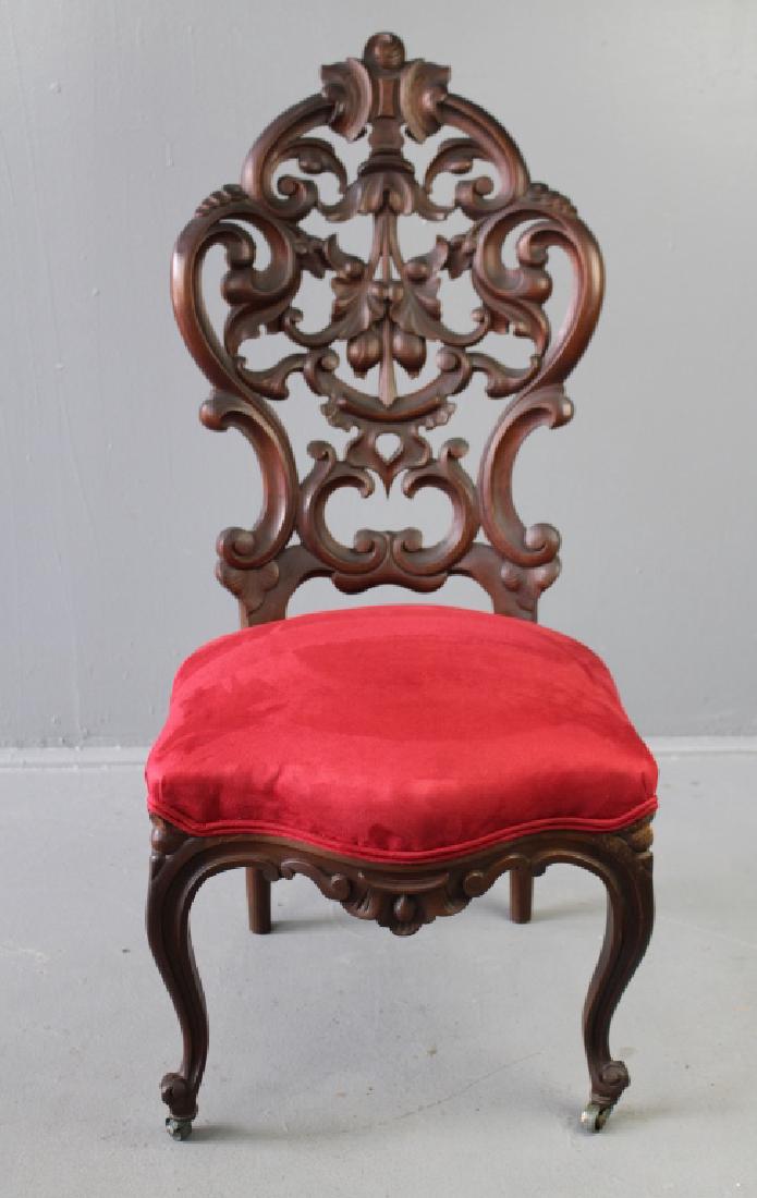 High Victorian Back Carved Chair: High Victorian back carved walnut chair, newly upholstered in red velvet, fine pierced carved back with cabriole front legs and apron, very good condition, c. 1865, 39" x 18" x 18".