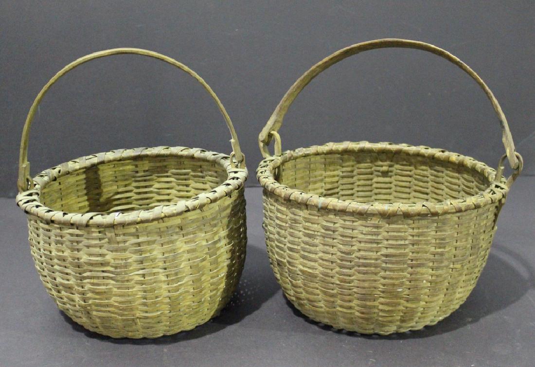 Two Early Splint Woven Baskets: Two early splint woven baskets, both with swing handles, almost twins, 12" diameter, 7" tall, handle is 20" arc, both in extraordinary condition, from Central North Carolina.