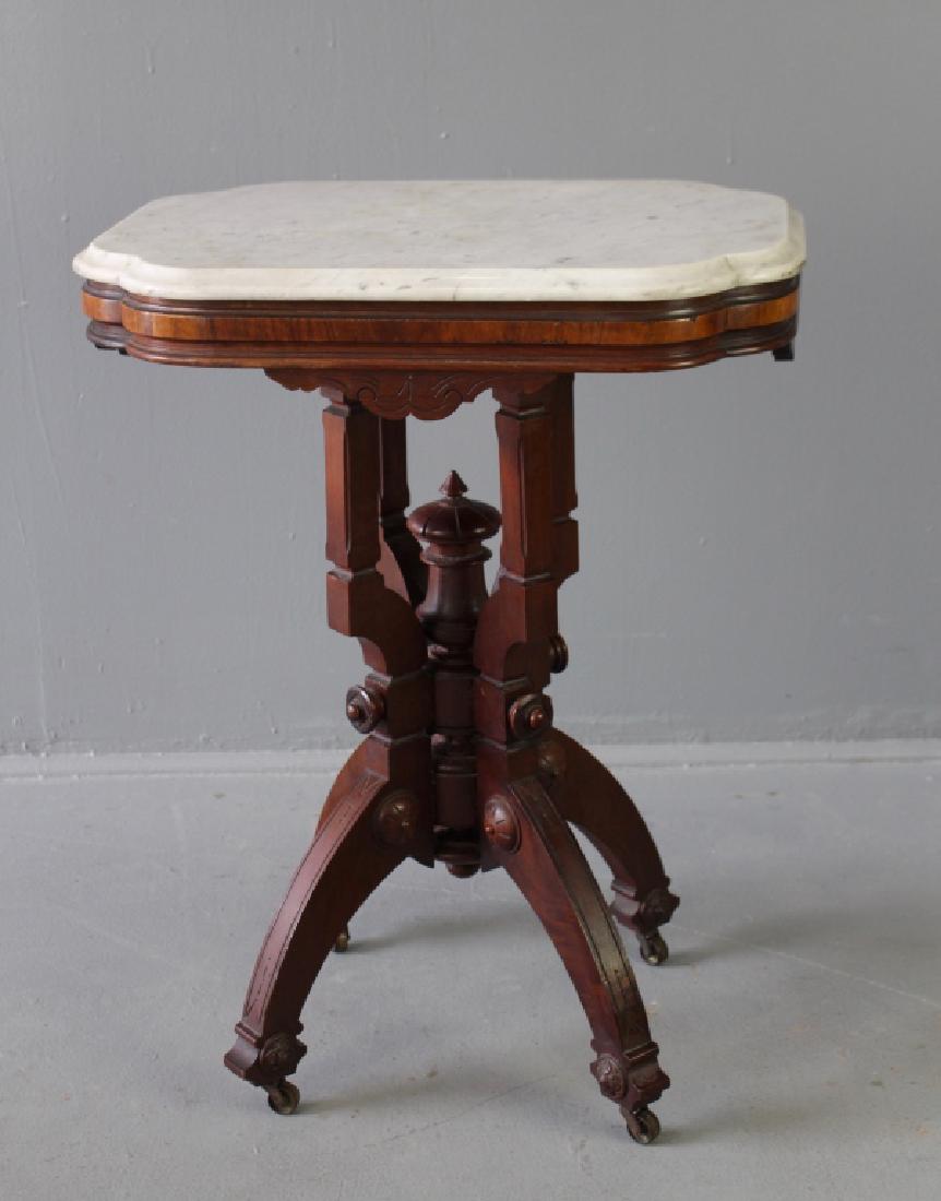 Petite Victorian Marble Top Table: Petite Victorian walnut marble top table, every bit original with all medallions, turnings aprons, casters and finish, in very good condition, shaped and beveled marble top (some minor scratching), 30