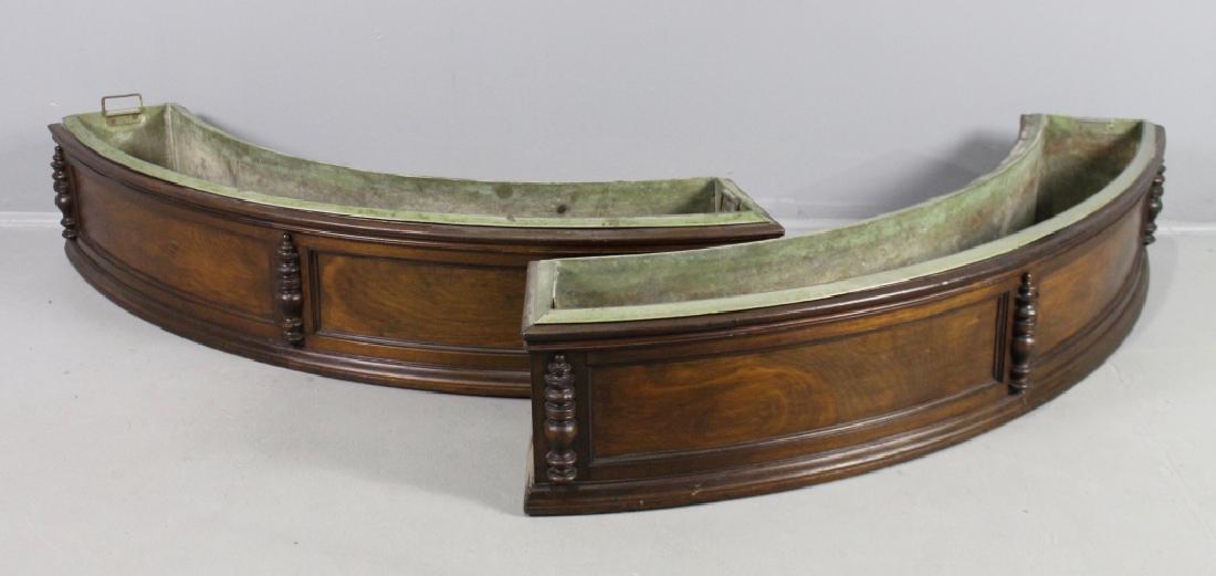 Pair Mahogany Planters with Liners: Pair of mahogany planters with lift out zinc liners. These are a generous 56" x 12" x 11' on a semi-circle arc. Recessed panels in front divided by decorative columns, very good condition, would work 