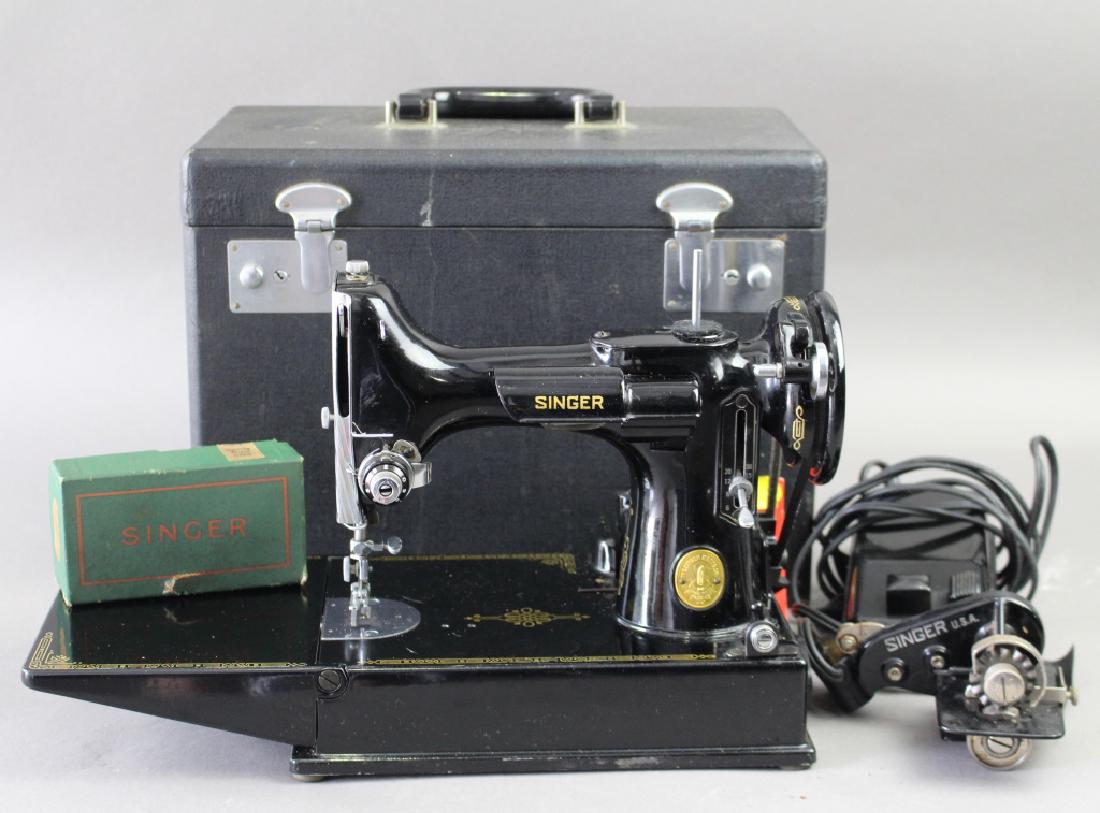 Singer Featherweight Sewing Machine: Singer Featherweight sewing machine in original carrying case, has hard to find button hole attachment, several bobbins with bobbin case, foot pedal, original instructions, like new!