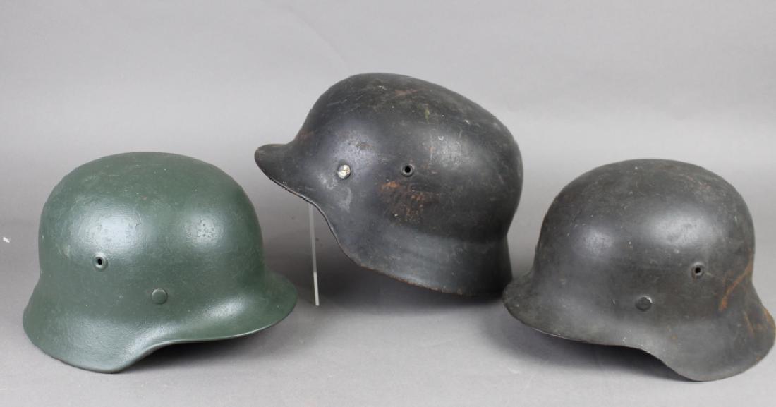 Three Nazi German WWII Military Helmets: Three Nazi German WWII military helmets: two are Nazi youth, all have intact leather support, good condition.