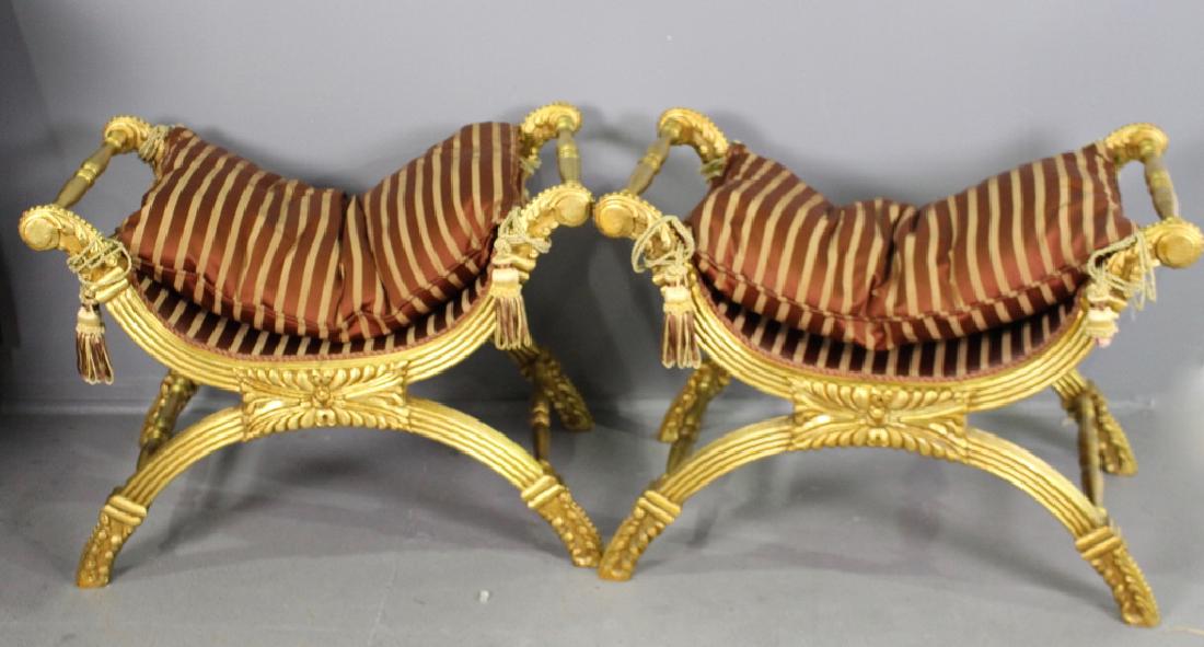 Pair Neo-Classical Style Campaign Stools: Pair Neo-classical style campaign stools, striped brick color pillow cushions with tassel ties, gold leaf carved and reeded frame, 22" h, 30" w, 19" d. good condition.