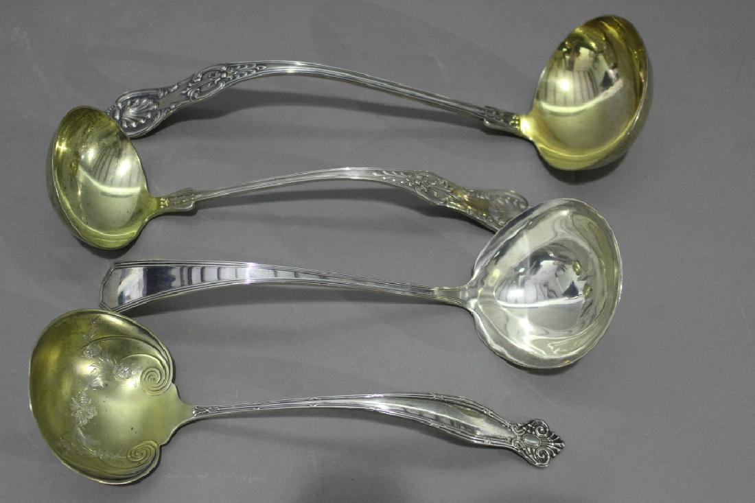 Four Sterling Ladles: Four large sterling silver ladles: Dominique and Haff "Queen Anne", c. 1910, Gorham "King's III", c. 1910, Towle "Empire", c. 1894, and oversize Bigelow & Kennard "Kings III" ladle with gold wash inte