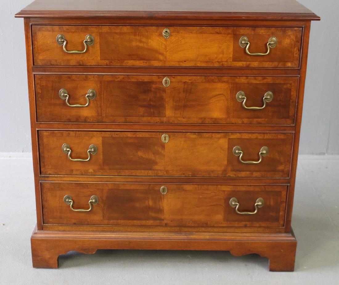 Chippendale Style 4-Drawer Chest: Chippendale style mahogany 4-drawer chest, parquetry grained fronts on the graduated drawers, top drawer locks, oak drawers, bracket feet, super condition, 20th century. 35" x 36" w x 18".