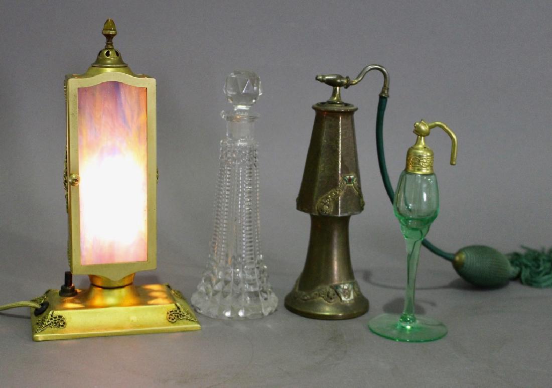 Group of Four Perfume Items: Group of four perfume items: Bronze with enameling 7.5" atomizer by Silver Craft, a 7" cut glass cologne bottle with stopper (rough on end), a green art glass atomizer (minus bulb), 6" possibly unmark