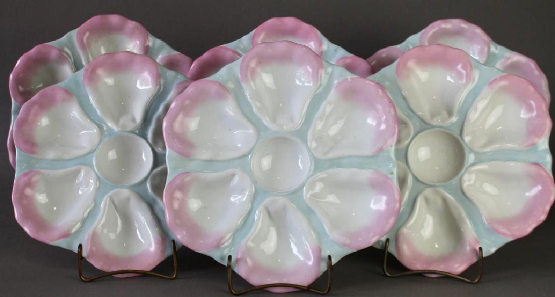 Set of Six Porcelain Oyster Plates: Set of six porcelain oyster plates, lovely pink and turquoise color on white surface, six oyster cups with cocktail sauce cup in center, unsigned, impressed 143 on bottom, all in excellent condition, 