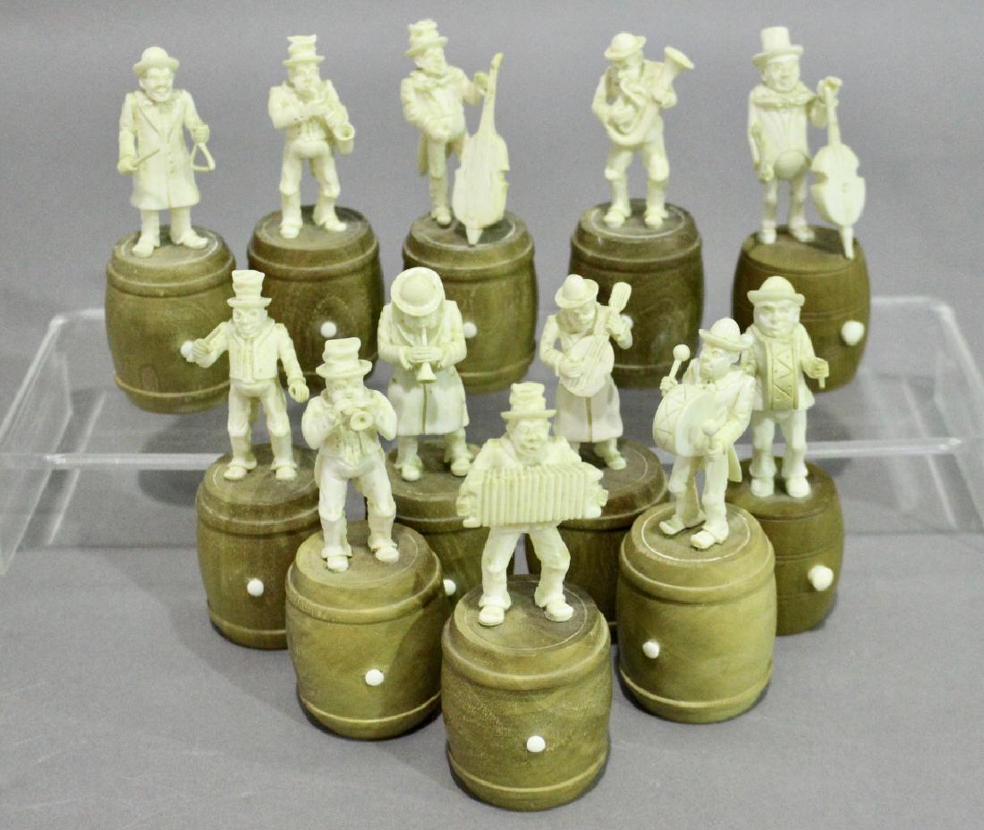 Set of Twelve Carved Pachyderm Musicians: all standing on wooden barrels, each playing a different instrument and pose, measurements from 4.5" to 5", from Dienne, France or northern Germany, c. 1890. Fine condition.