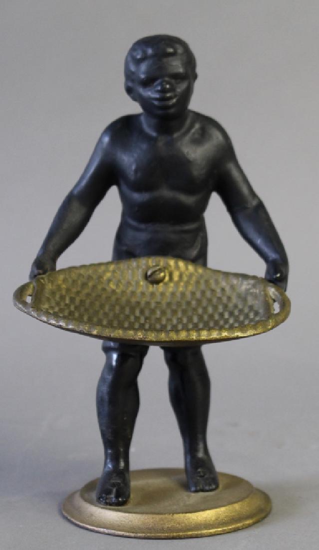 Vintage Cast Iron Blackamoor: carte de viste holder, c. 1890-1900, young black boy holding a basket tray, 9" x 5" x 6", good condition.