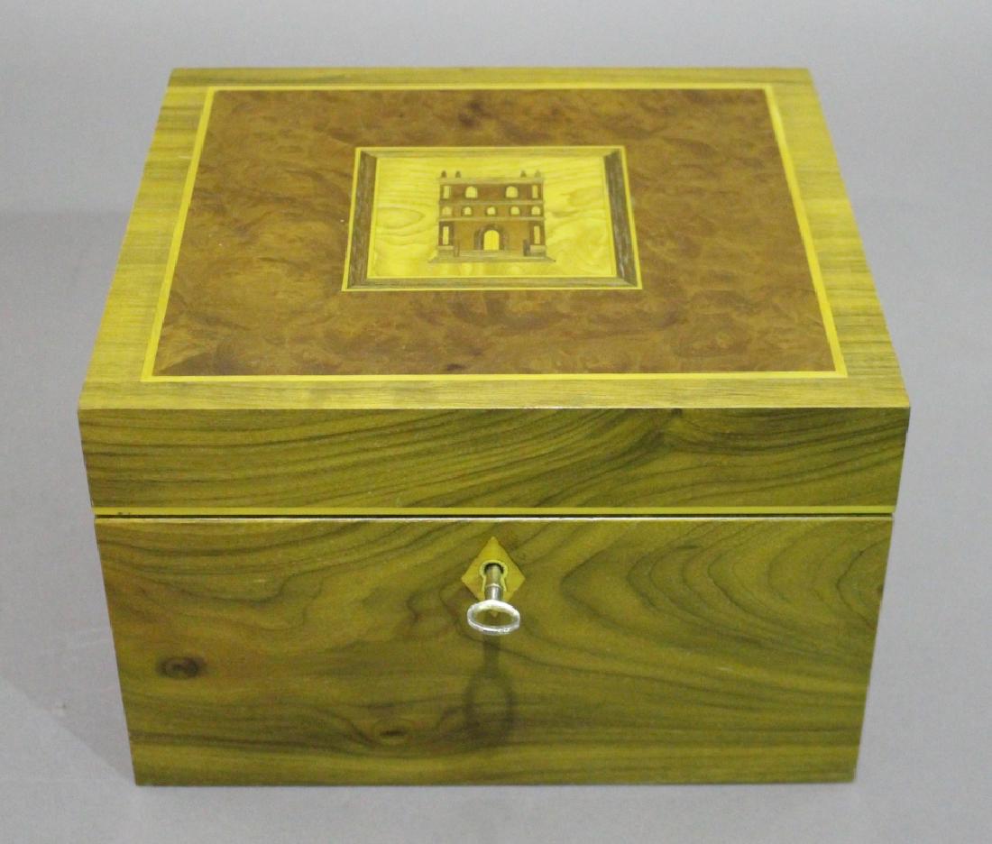 David Linley for Dunhill Humidor: with fine inlay, locking, beautiful light hardwood grain exterior with inlay top of house of burled veneers, very good condition with accessories, and book, "The Cigar", 9.75"w, 8.75"d, 6.25"h.