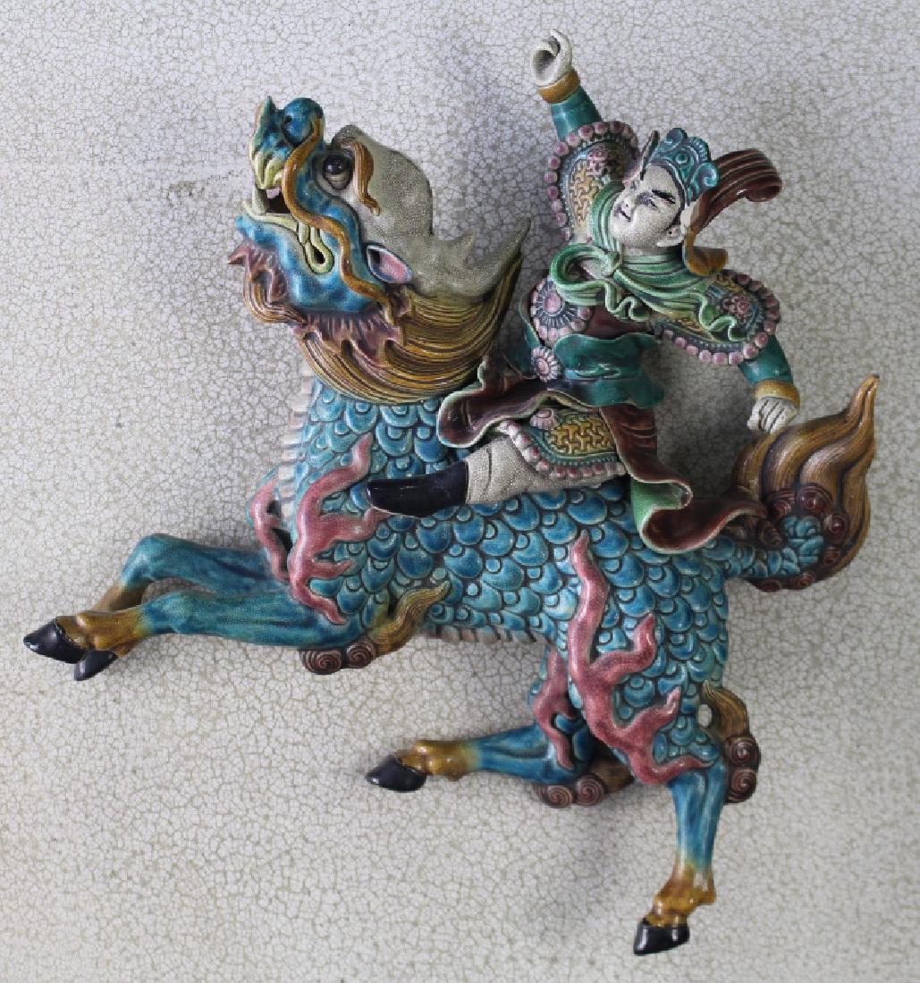 Chinese Polychrome Ceramic Roof Tile: depicts warrior atop galloping horse, attached to 26.5" square frame, one ear guard on warrior's helmet missing, otherwise exceptional condition and workmanship, figure is 15" x 16" x 4".