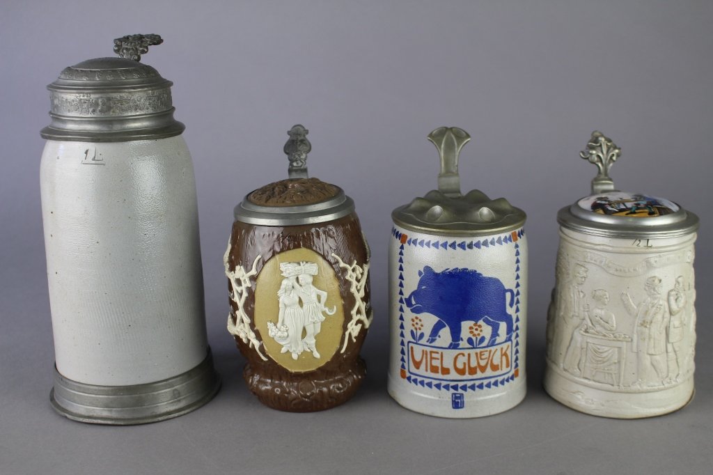 Four German Steins: a 1 liter stoneware stein with etched pewter lid reading "Hotel Bubruhanit 1888" a 1/2 liter "Viel Glueck" boar stoneware stein, a 1/2 liter raised cameo stein with porcelain inset lid and a Mettlach 