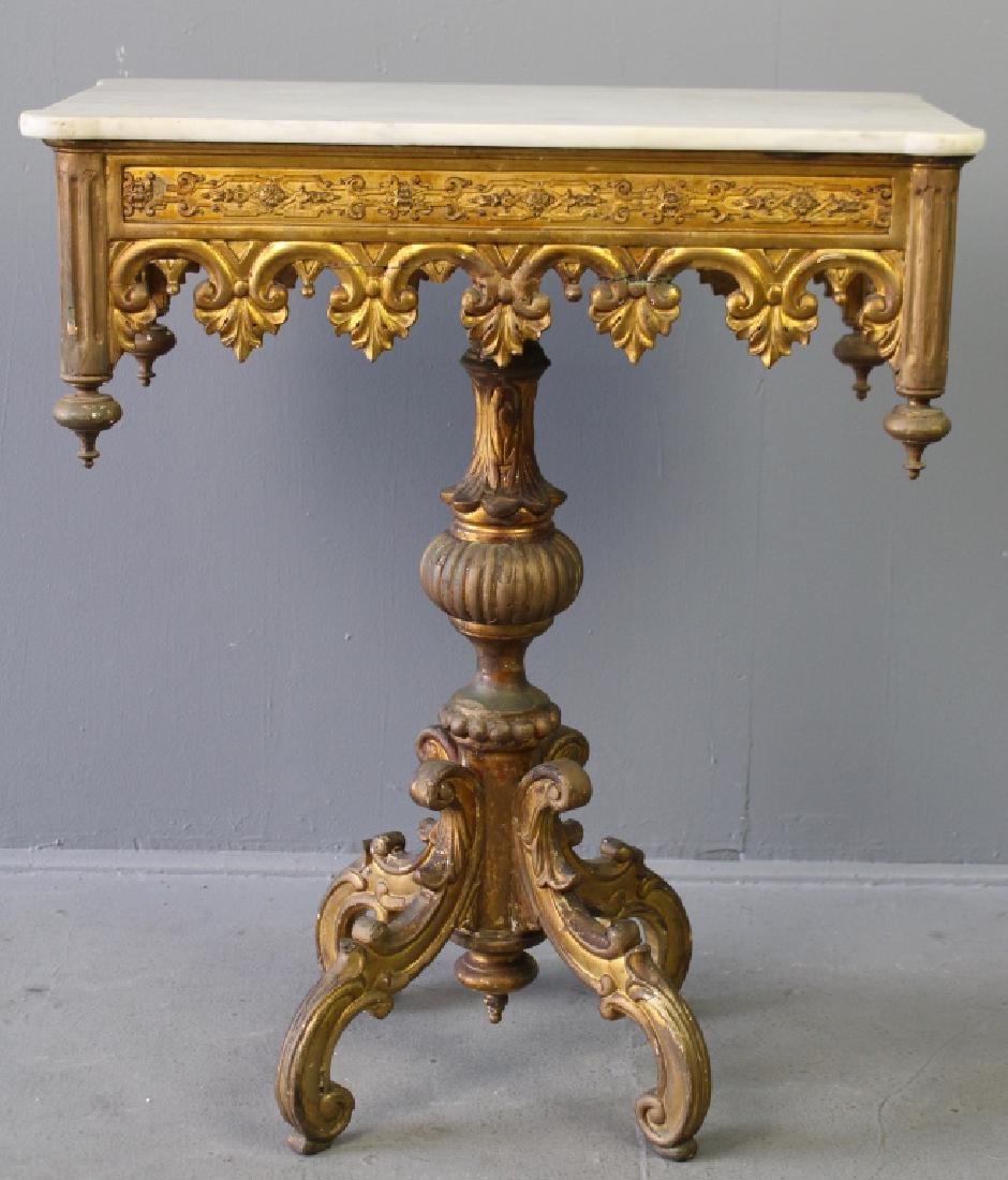 Rococo or George III Gilt Wood Table: with white marble top, mid 18th century, long apron with finial corners, gothic carved arch border, large reeded ball in center column, profusely carved cabriole legs, in good condition for age with w
