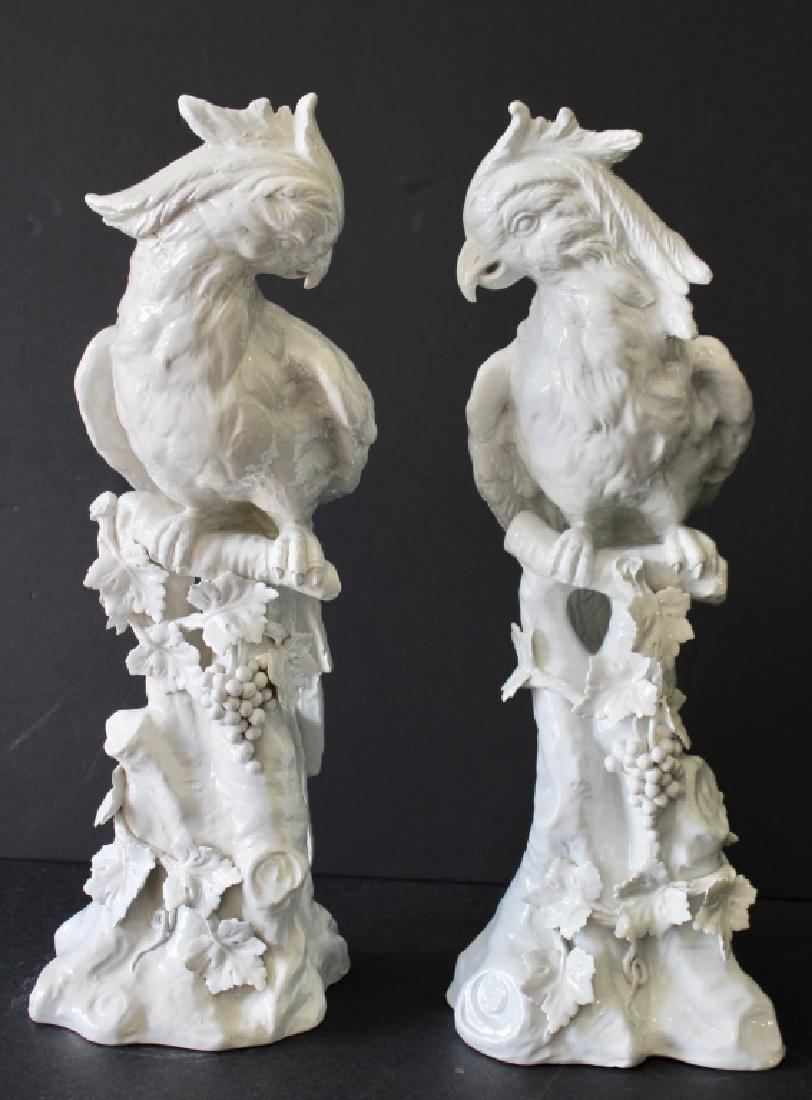 Pair Italian White Porcelain Figural Parrots: Regal Hollywood style, c. 1950-55, Mid-Century, blur of a blue mark under glaze on one, one has tip of crown re-glued (thankfully not lost), otherwise good condition, 22" x 9" x 9".