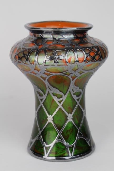 Loetz Titania Vase: with sterling silver overlay, classical shape with broad shoulder tapered base, and flared mouth, beautiful orange and green colors, orange interior. 8" tall, marked "Sterling". Note: There is a tiny